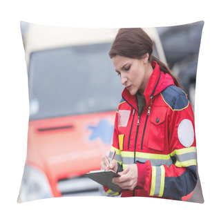 Personality  Concetrated Female Paramedic In Uniform Writing In Clipboard Pillow Covers
