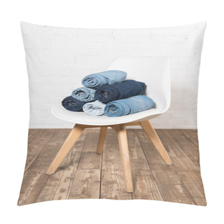 Personality  Rolled Denim Garments On White Chair Placed On Wooden Floor Near Brick Wall Pillow Covers