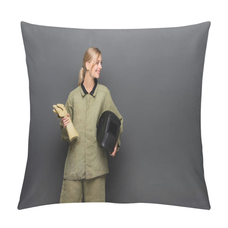 Personality  Young Blonde Welder Holding Helmet And Gloves While Looking Away On Grey Background Pillow Covers