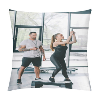 Personality  Young Sportswoman Doing Step Aerobics Exercise And Male Personal Trainer With Timer In Hand At Gym Pillow Covers