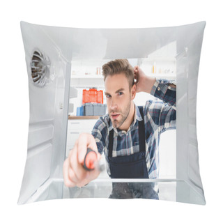 Personality  Young Thoughtful Repairman With Screwdriver Looking At Camera In Freezer On Blurred Foreground Pillow Covers