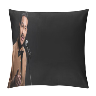 Personality  Indian Comedian Telling Jokes Into Microphone And Pointing With Finger While Looking At Camera Isolated On Black, Banner Pillow Covers