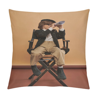 Personality  Cute Boy In Stylish Clothing Sits On Director Chair And Looking Through Hole In Rolled Paper Pillow Covers