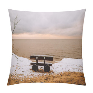 Personality  An Empty Wooden Bench Overlooking A Calm Sea, With Snow On The Ground And A Cloudy Sky Above. Pillow Covers