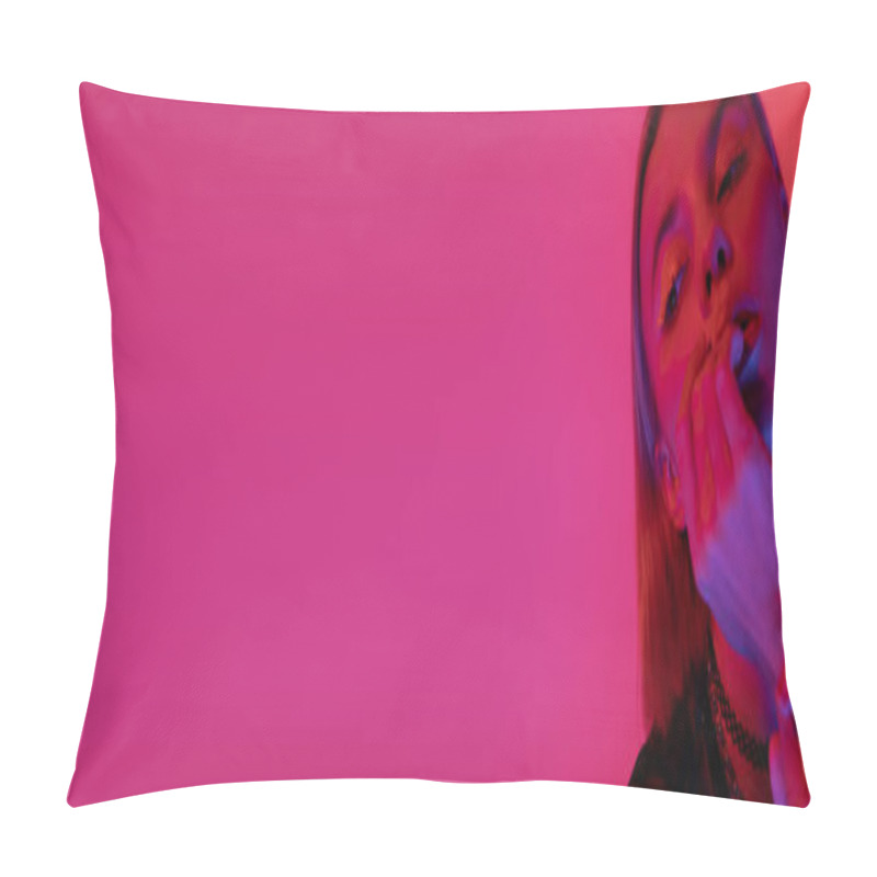 Personality  woman with neon makeup holding hand near face on deep pink background with copy space, banner pillow covers