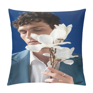 Personality  Portrait Of Curly Young Man In Jacket Holding Blurred Magnolia Branch Isolated On Blue  Pillow Covers