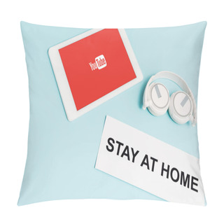 Personality  KYIV, UKRAINE - APRIL 8, 2020: Digital Tablet With Youtube App Near Headphones And Paper With Stay At Home Lettering On Blue  Pillow Covers