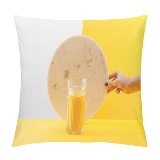Personality  Cropped View Of Woman Holding Marble Circle Near Glass Of Fresh Delicious Yellow Smoothie On Grey And Yellow Background Pillow Covers