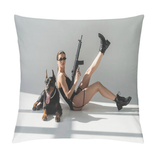 Personality  Young Woman In Black Bodysuit And Sunglasses Posing With Rifle Near Doberman On Grey Background With Shadows Pillow Covers