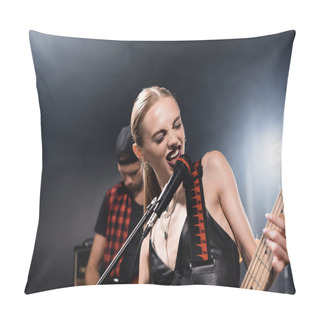 Personality  KYIV, UKRAINE - AUGUST 25, 2020: Rock Band Vocalist With Electric Guitar Singing In Microphone With Backlit And Blurred Man On Background Pillow Covers