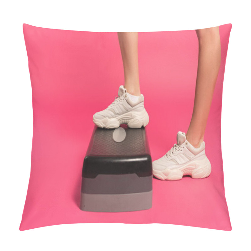 Personality  cropped view of sportswoman standing on step platform on pink  pillow covers