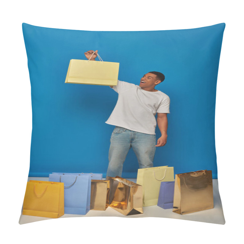 Personality  Excited African American Man In Casual Attire Holding Shopping Bags On Blue Backdrop, Buying Spree Pillow Covers