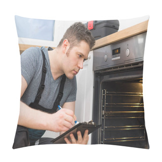 Personality  Handyman Doing Inspection Of Domestic Oven In The Kitchen. Pillow Covers