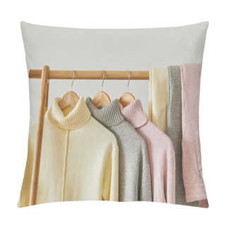 Personality  Close Up View Of Pink, Beige And Grey Knitted Soft Sweaters And Pants Hanging On Wooden Rack Isolated On White Pillow Covers