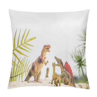 Personality  Selective Focus Of Toy Dinosaurs On Sand Dune Among Tropical Plants Pillow Covers