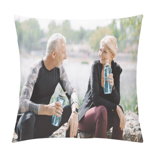 Personality  Cheerful Mature Sportsman And Sportswoman Looking At Each Other While Sitting On Parapet With Sports Bottles Pillow Covers