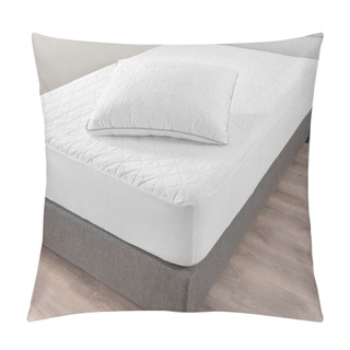 Personality  Close-up View Of Pristine White Bed, Geometric Quilting On Mattress And Pillow, Contrasting With Soft Gray Upholstered Bed Frame, Comfort, Set Against A Warm Wooden Floor Background. White Walls. Pillow Covers