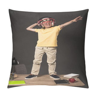 Personality  Smiling Schoolboy In American Football Helmet Imagining That He Throwing Ball And Standing On Table With Books, Plant, Lamp, Colour Pencils, Apple, Clock And Textbook On Grey Background  Pillow Covers