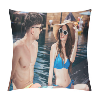 Personality  Cheerful Young Couple Looking At Each Other And Smiling While Relaxing On Poolside Pillow Covers