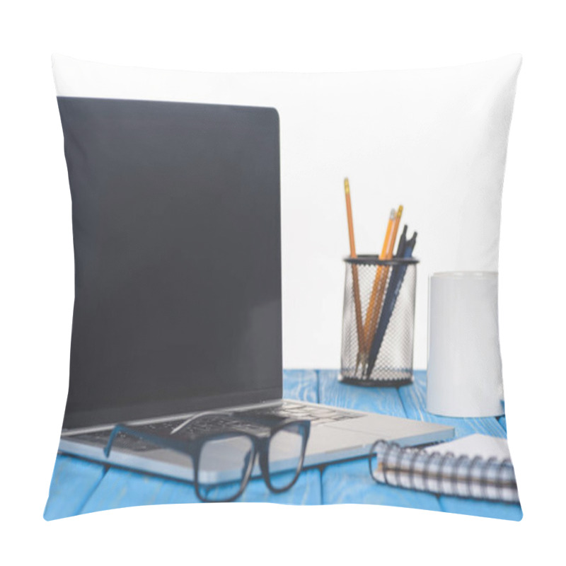 Personality  closeup shot of eyeglasses on laptop, textbook, organizer with stationery and mug  pillow covers