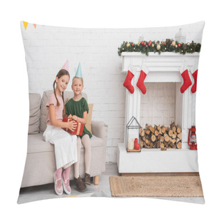 Personality  Smiling Friends In Party Caps Holding Present On Couch Near Christmas Decor At Home  Pillow Covers