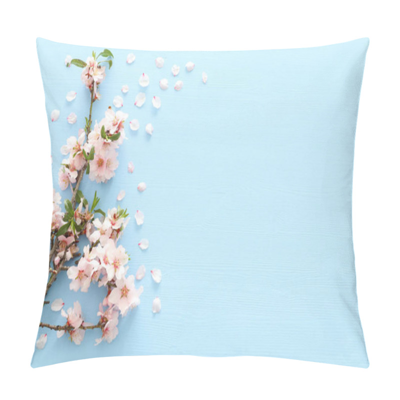 Personality  photo of spring white cherry blossom tree on blue wooden background. View from above, flat lay pillow covers