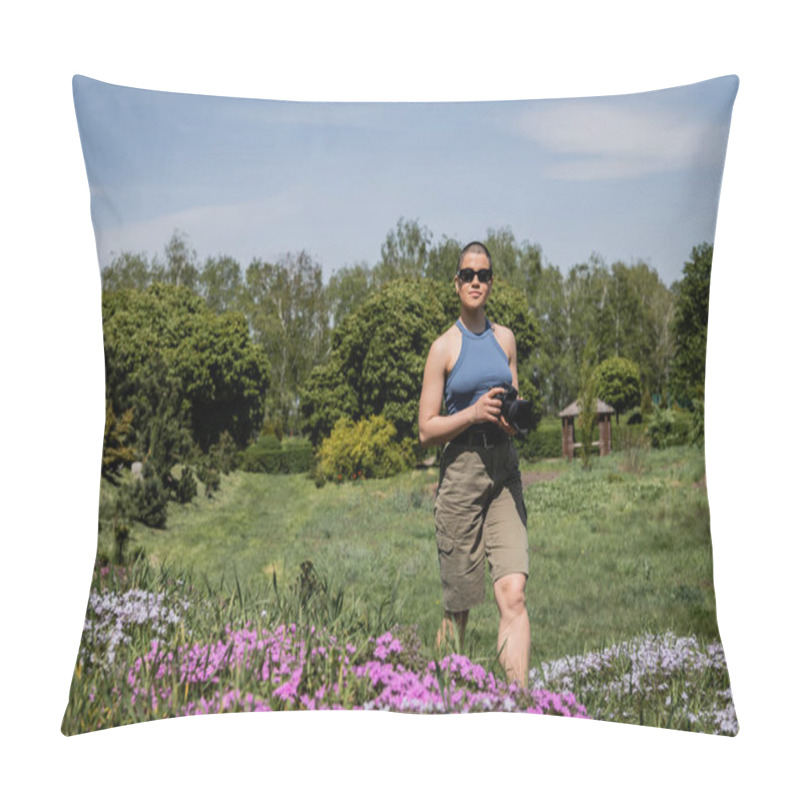 Personality  Young Short Haired Woman Tourist In Sunglasses Holding Digital Camera While Standing Near Blurred Flowers With Blurred Scenic Landscape At Background, Translation Of Tattoo: Love Pillow Covers