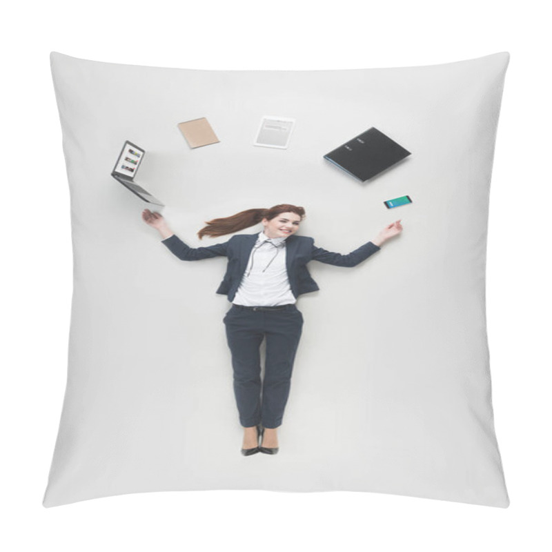 Personality  overhead view of businesswoman with various office supplies using laptop isolated on grey pillow covers