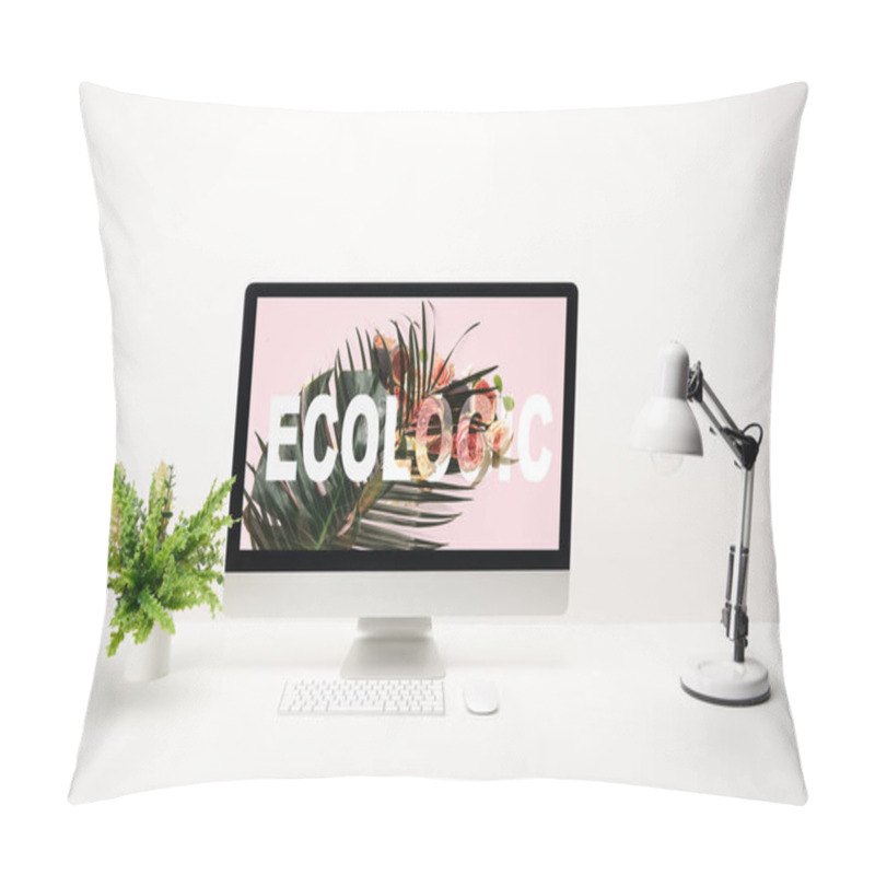 Personality  computer with ecologic lettering and tropical leaf on monitor on desk on white background pillow covers