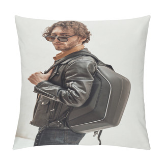 Personality  Portrait Of A Handsome Guy With Curly Hair Posing In The Bright Studio Wearing Sunglasses, Leather Coat And A Backpack Pillow Covers