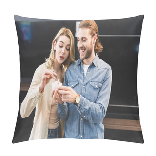 Personality  Smiling Boyfriend Holding Piggy Bank And Girlfriend Putting Coin Into It In Home Appliance Store  Pillow Covers