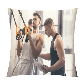 Personality  Trainer Using Digital Tablet And Helping Muscular Sportsman Exercising With Fitness Straps In Gym Pillow Covers