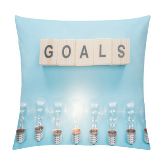 Personality  Top View Of Glowing Light Bulbs Under 'goals' Word Made Of Wooden Blocks On Blue Background, Goal Setting Concept Pillow Covers
