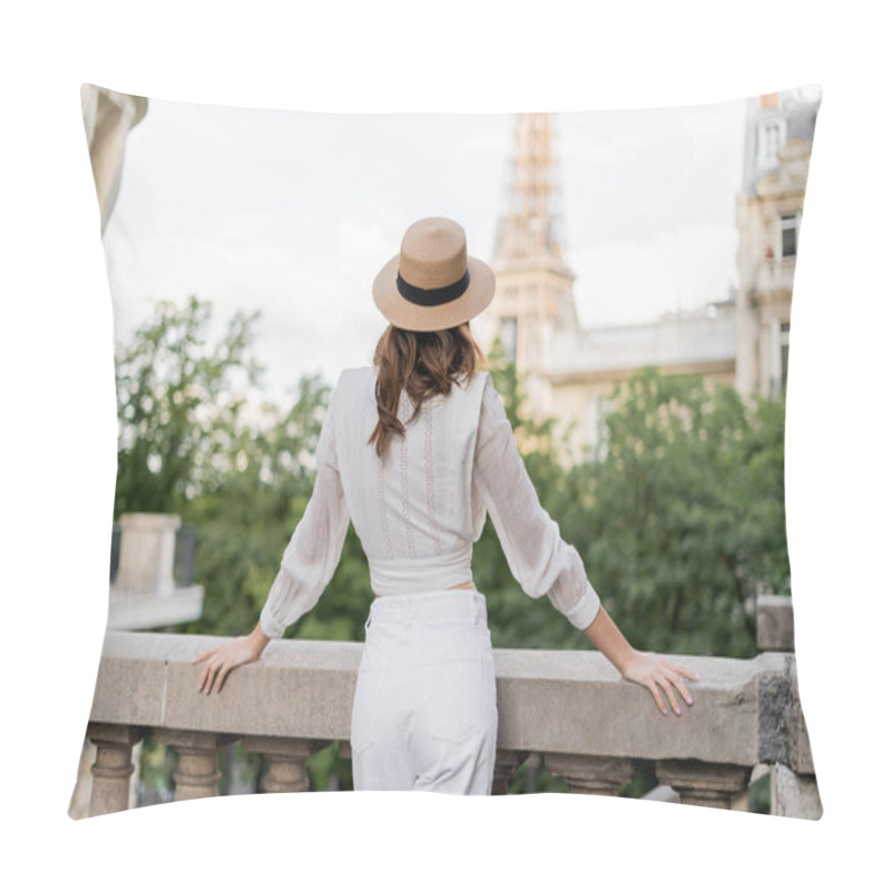 Personality  Back view of tourist in sun hat standing with blurred Eiffel tower at background in Paris pillow covers