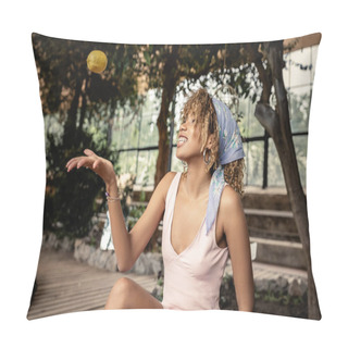 Personality  Cheerful Young African American Woman With Braces Wearing Headscarf And Summer Dress While Throwing Ripe Lemon And Sitting In Blurred Garden Center, Chic Woman In Tropical Garden, Summer Concept Pillow Covers