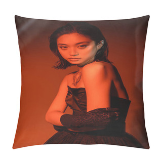 Personality  Portrait Of Beautiful Asian Woman With Short Hair And Wet Hairstyle Posing In Strapless Dress And Glove With Trendy Cuff Earring And Necklaces On Dark  Orange Background With Red Lighting  Pillow Covers
