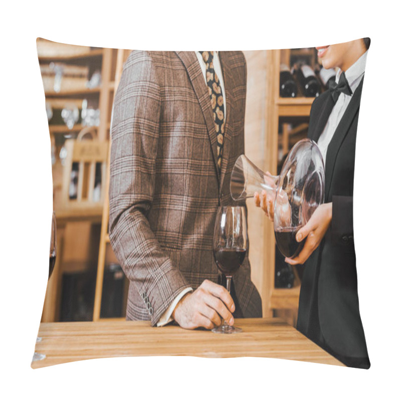 Personality  cropped shot of female wine steward wine for customer from decanter at wine store pillow covers