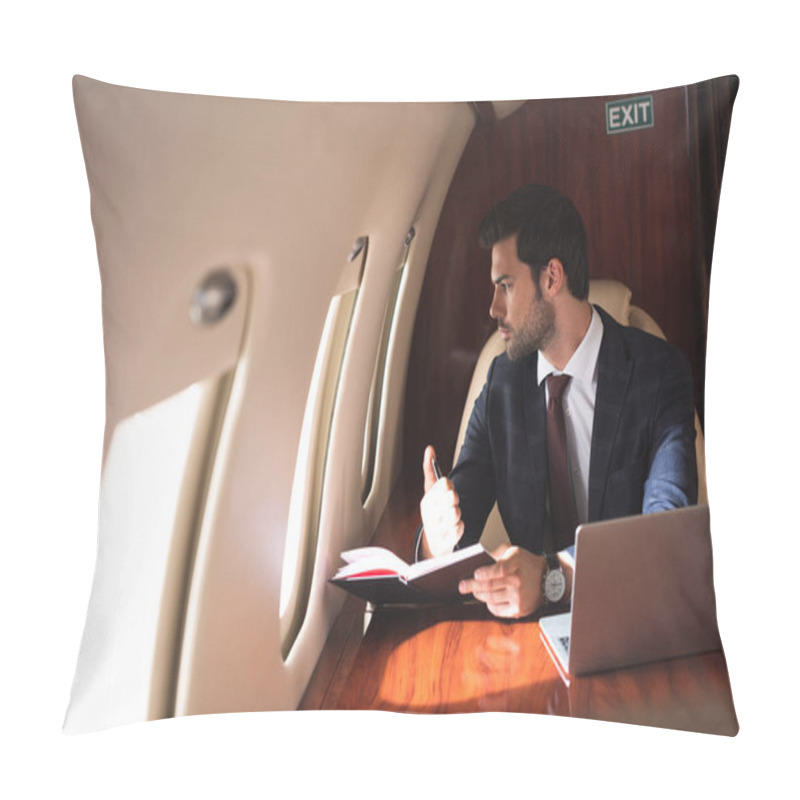 Personality  young businessman working with notebook and laptop in plane during business trip  pillow covers