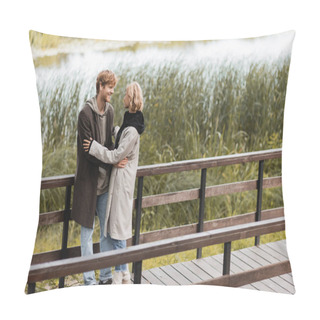 Personality  Full Length Of Redhead Man And Blonde Woman In Coat Smiling While Hugging On Bridge Near Lake In Park  Pillow Covers