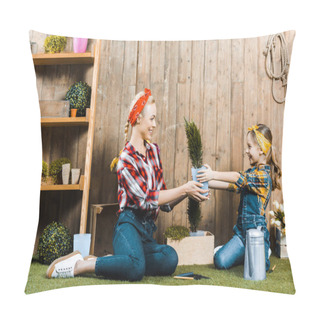 Personality  Happy Mother And Cute Daughter Holding Plant While Sitting On Grass Near Wooden Fence Pillow Covers