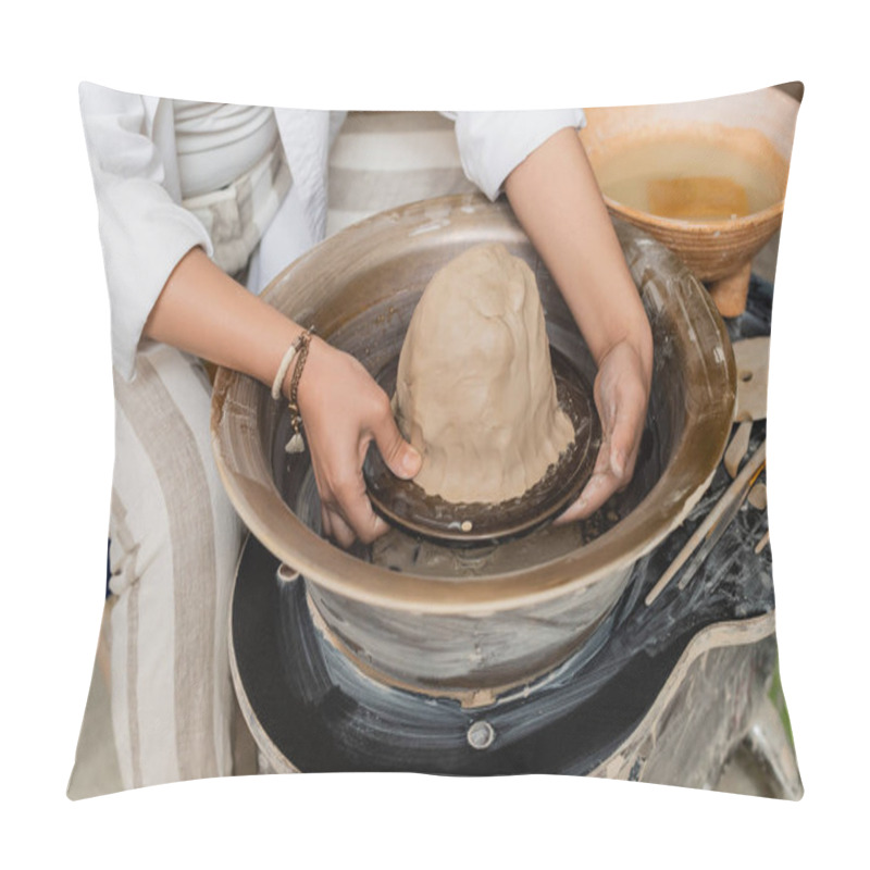 Personality  Cropped view of young female artisan in workwear working with clay on pottery wheel, tools and bowl with water at background in ceramic workshop, pottery artist showcasing craft pillow covers