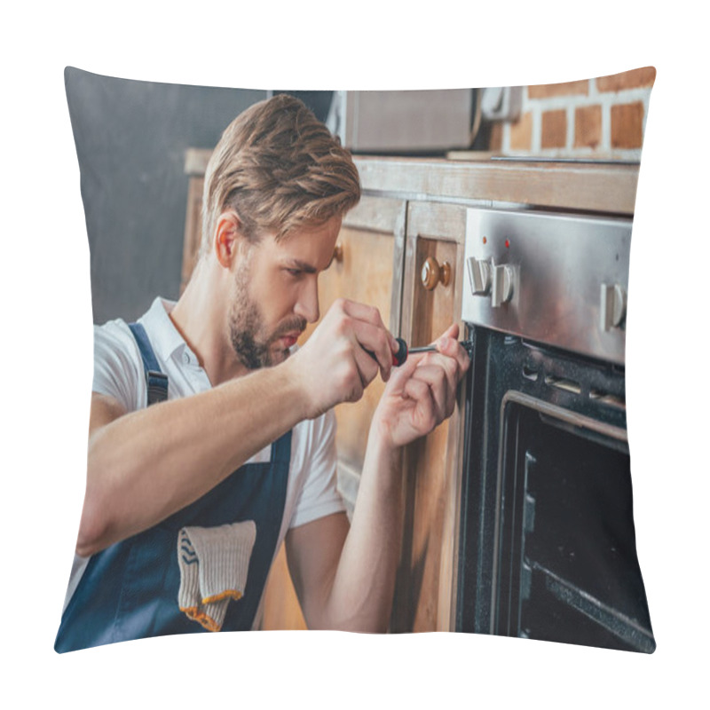 Personality  handsome young repairman fixing oven with screwdriver pillow covers