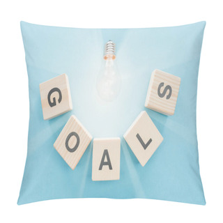 Personality  Top View Of Glowing Light Bulb Over 'goals' Word Made Of Wooden Blocks On Blue Background, Goal Setting Concept Pillow Covers