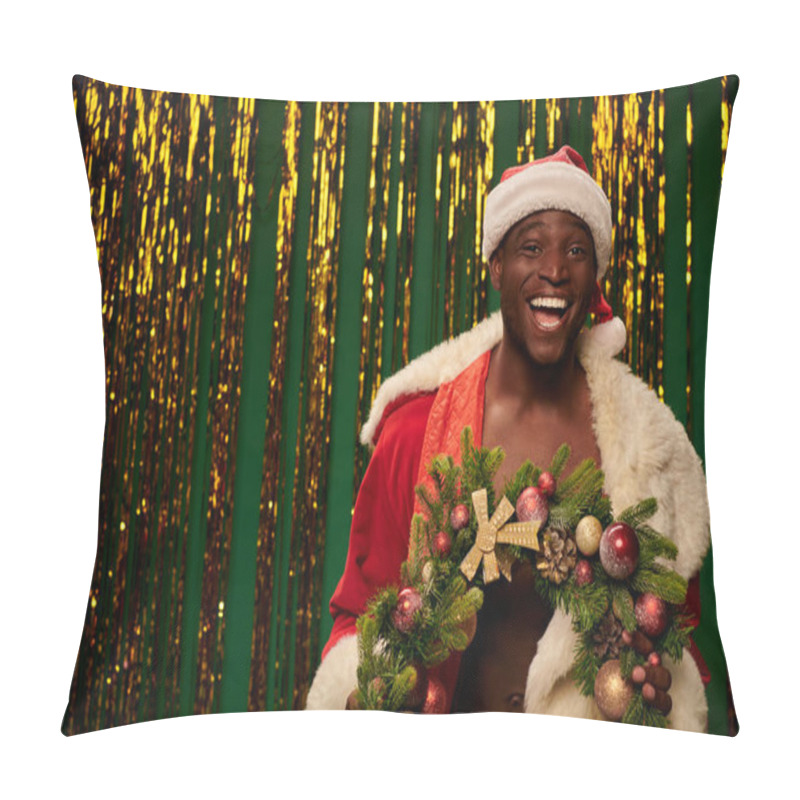 Personality  Laughing African American Guy In Santa Costume With Christmas Wreath Near Shiny Decor On Green Pillow Covers