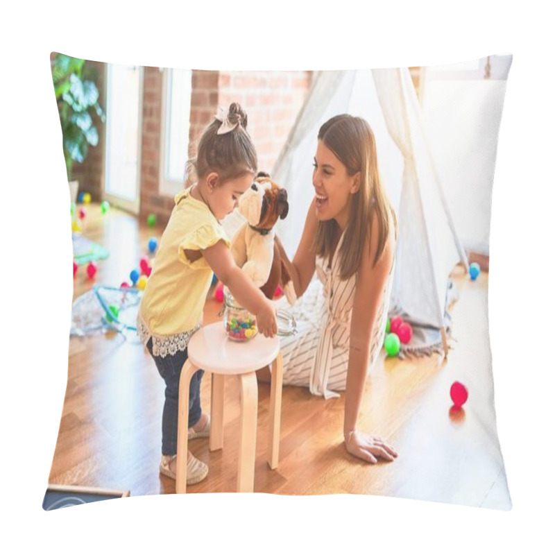 Personality  Young beautiful teacher playing with dog doll and toddler holding jar of chocolate balls at kindergarten pillow covers