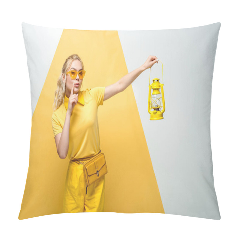 Personality  attractive blonde woman in sunglasses gesturing and holding vintage lamp on white and yellow  pillow covers