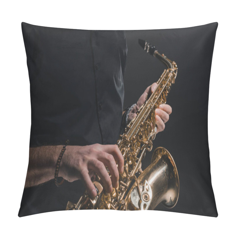 Personality  cropped shot of man playing saxophone on black pillow covers