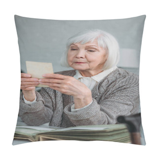 Personality  Portrait Of Grey Hair Woman Looking At Photo From Photo Album At Table At Home Pillow Covers