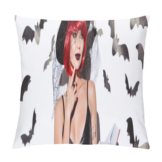 Personality  Panoramic Shot Of Thoughtful Girl In Black Witch Halloween Costume With Red Hair Holding Book Near White Wall With Decorative Bats Pillow Covers