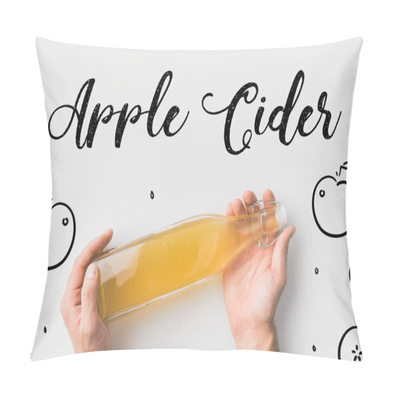 Personality  top view of person holding bottle of cider with hand drawn apples and lettering on white surface pillow covers